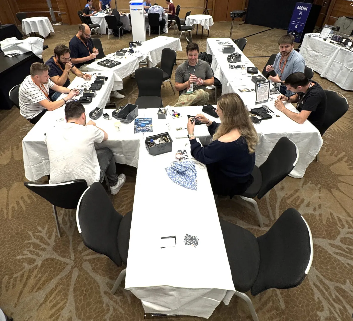 Lockpicking workshop tables at 44CON, attendees working on locks
